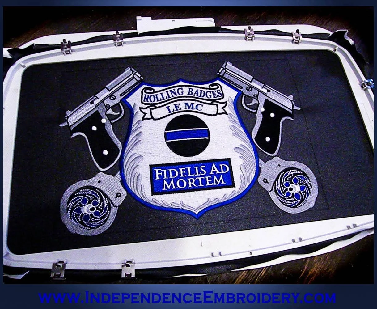 A large embroidered law enforcement motorcycle club center patch held in an embroidery hoop on the machine, made by Independence Embroidery in Owensville, Missouri.