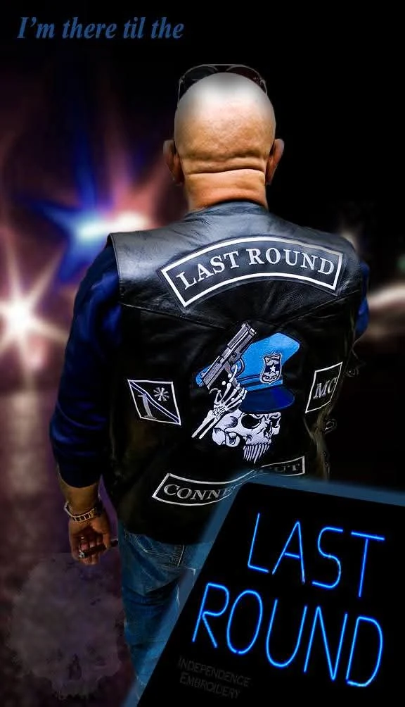 A motorcycle club member seen from behind wearing a black leather vest with a full set of embroidered colors, made by Independence Embroidery in Owensville, Missouri.