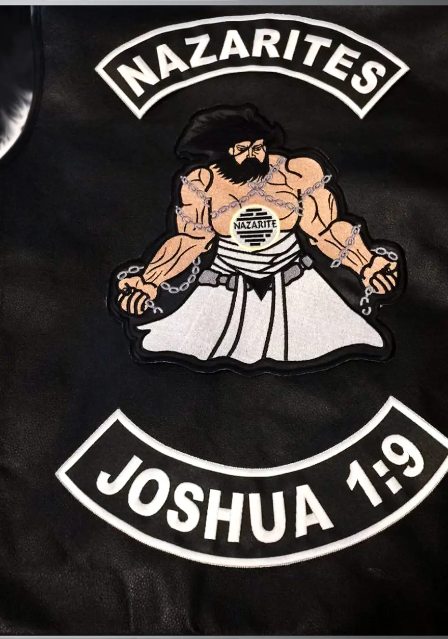An embroidered patch set mounted on a black leather vest, made by Independence Embroidery in Owensville, Missouri.