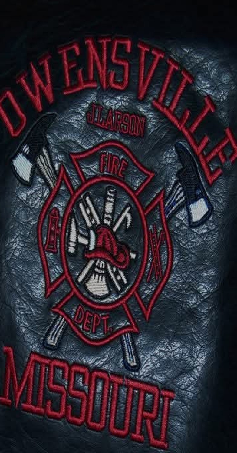 An Owensville, Missouri Fire Department emblem and a name embroidered directly onto a black leather jacket.