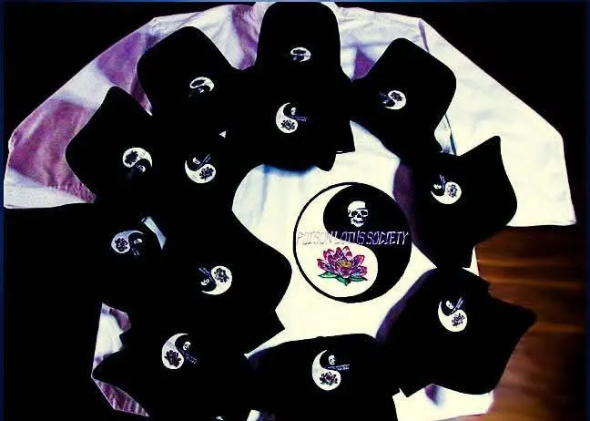 Embroidered caps and shirts arranged together, every piece carrying the same emblem, made by Independence Embroidery in Owensville, Missouri.